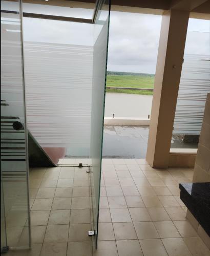 a glass shower door in a bathroom with a view at Rio Vista in Rāzole