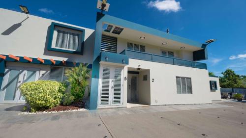 a blue and white house with a garage at Aquaville Dorado Moderna Villa 3 in Dorado