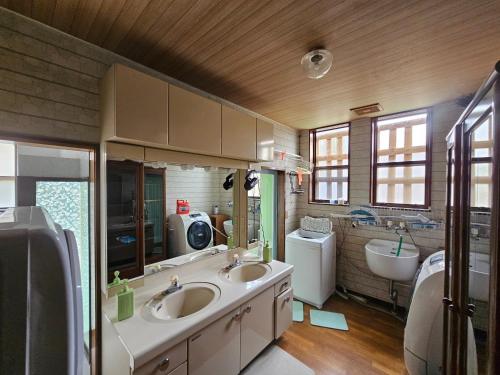 a large bathroom with two sinks and a tub at Mogamigun - House - Vacation STAY 20251 in Shinjo