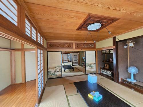 a living room with a wooden ceiling and a table at Mogamigun - House - Vacation STAY 20251 in Shinjo