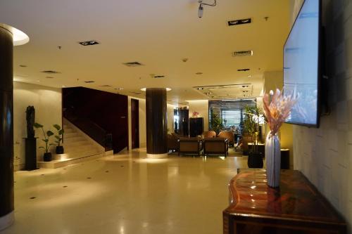 a living room with a television and a lobby at Regal Pacific Puerto Madero in Buenos Aires