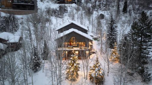 a cabin in the snow with christmas lights on it at Creekside Chalet in Steamboat Springs