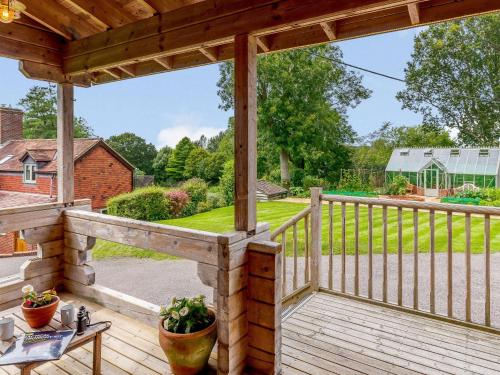 a wooden deck with a view of a yard at 2 Bed in Blandford Forum 61027 in Child Okeford