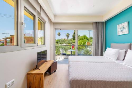 a hotel room with two beds and a window at Villa Daphne Gouvia by Villa Plus in Gouvia