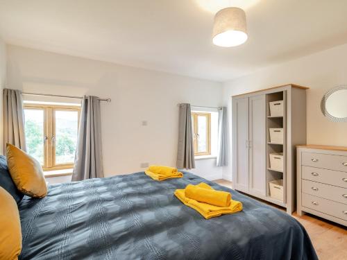 a bedroom with a bed with yellow towels on it at 5 Bed in Builth Wells 92709 in Beulah