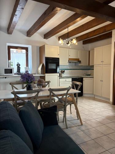a kitchen and dining room with a table and chairs at Relais du Dompeter in Molsheim