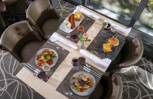 a table with two plates of food on it at Leonardo Hotel Hannover in Hannover