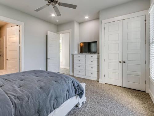 a bedroom with a bed and a flat screen tv at Shore Enough, Carlton Landing, Lakeview for 12 in Carlton Landing