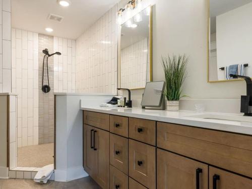 een badkamer met een wastafel en een spiegel en een douche bij Barefoot Dreams in Winchester