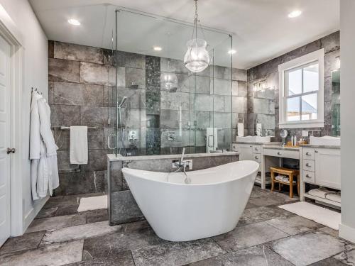 a large bathroom with a tub and a sink at Shore Enough, Carlton Landing, Lakeview for 12 in Carlton Landing