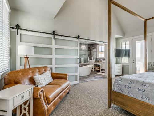 a bedroom with a couch and a bed and a tub at Shore Enough, Carlton Landing, Lakeview for 12 in Carlton Landing