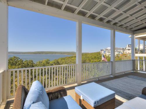 a screened in porch with a view of the water at Shore Enough, Carlton Landing, Lakeview for 12 in Carlton Landing