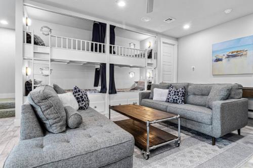 a living room with two couches and a bunk bed at Shore Enough, Carlton Landing, Lakeview for 12 in Carlton Landing