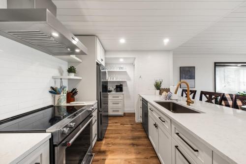 a kitchen with white counters and a sink and a stove at 1338 Pelican Watch Villa in Seabrook Island