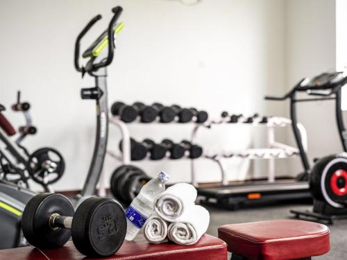 a gym with dumbbells and weights on a table at Nungwi Dreams by Mantis in Nungwi