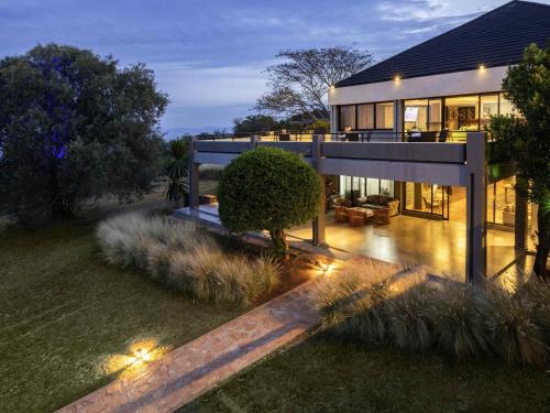 a large house with lights in front of it at Mantis Akagera Game Lodge in Akagera