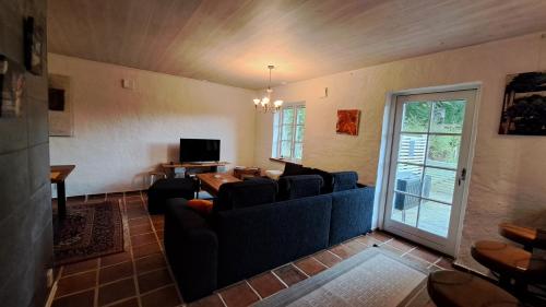 a living room with a couch and a table at Beautiful and cosy house near the lake in Olofström