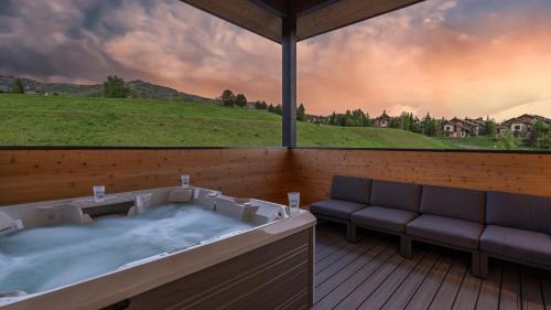 a jacuzzi tub on a deck with a view at Friesian Chalet in Steamboat Springs