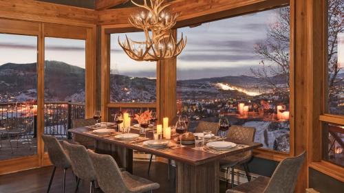 a dining room with a table and a large window at Glacier Grande in Steamboat Springs