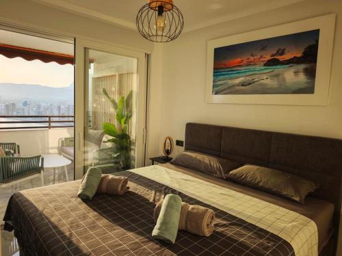 a bedroom with a bed with a view of the city at Sea&Skyline Suites Benidorm in Benidorm