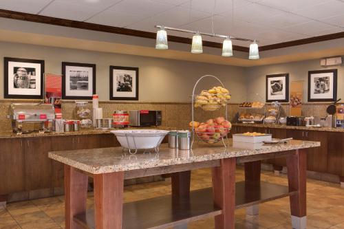 a large kitchen with a table with fruit on it at Hampton Inn and Suites - Lincoln Northeast in Lincoln