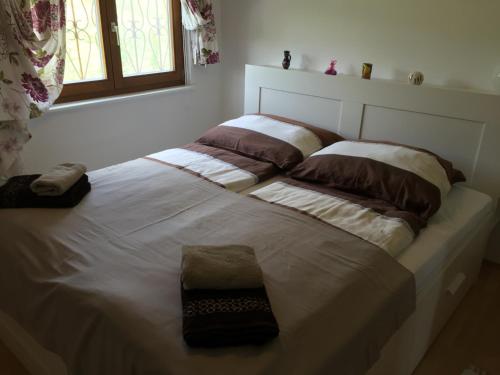 a bed with two pillows on it in a bedroom at Eisenberg Chalet in Eisenberg an der Pinka