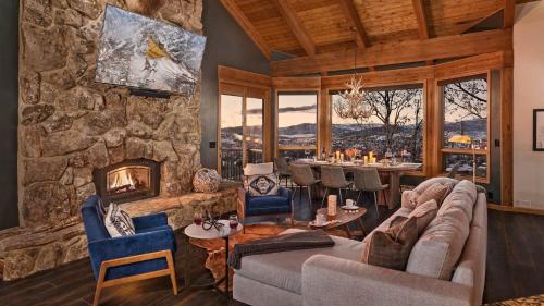 a living room with a couch and a fireplace at Glacier Lodge - West in Steamboat Springs