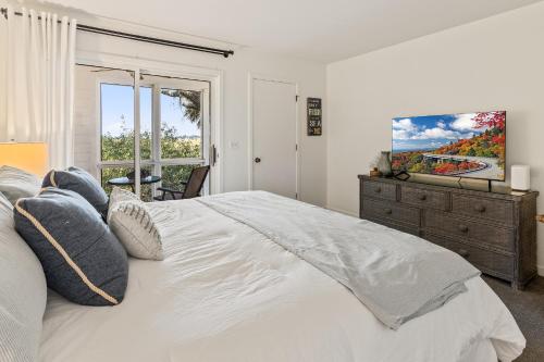 a bedroom with a large white bed and a window at 1806 Heron Point in Summerville