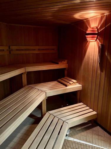 a sauna with two wooden benches in it at Travemünde Ruheoase mit Pool Sauna Parkplatz in Rönnau