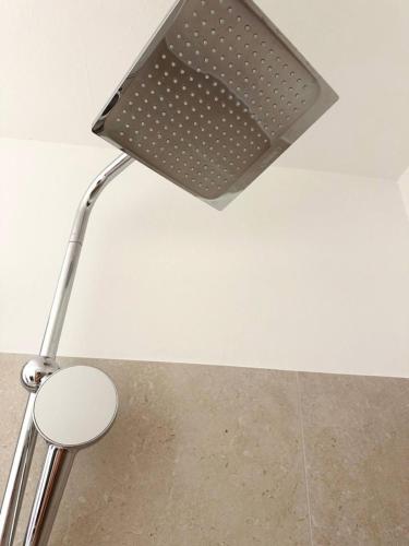 a lamp on the ceiling of a room with a stool at Travemünde Ruheoase mit Pool Sauna Parkplatz in Rönnau