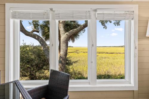 a window with a view of a tree and a field at 1806 Heron Point in Summerville