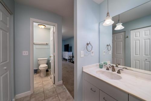 Un baño con lavabo, inodoro y espejo. en 1905 Bohicket Marina, en Seabrook Island