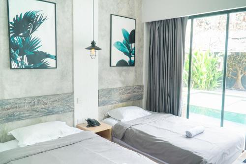 Katil atau katil-katil dalam bilik di Gemini Star Hotel Kuta