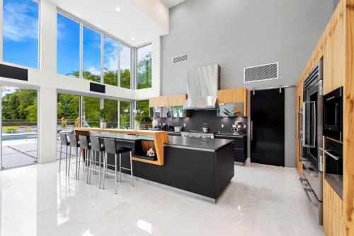 a kitchen with black and white appliances and windows at Modani Estates in Miami