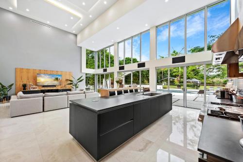 a large kitchen with a black island in a living room at Modani Estates in Miami