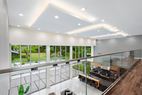 a large room with a balcony with windows at Modani Estates in Miami