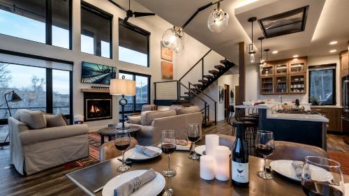 a living room with a table with wine glasses at Hilltop Chateau in Steamboat Springs