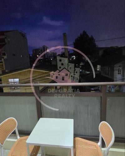 a white table and two chairs on a balcony at Megatower 3 GF17 Baguio Condo by Dei Gratia in Baguio