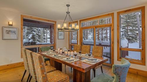 a dining room with a table and chairs and windows at Inglenook in Breckenridge
