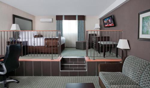 a hotel room with a bed in a cage at Coast Lethbridge Hotel & Conference Centre in Lethbridge