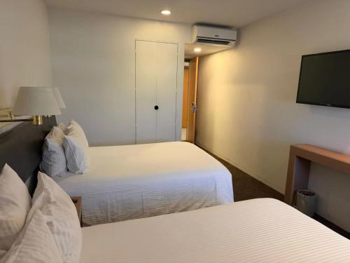 Hotel VM Express Queretaroにあるベッド