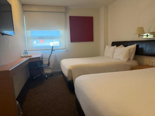 Hotel VM Express Queretaroにあるベッド