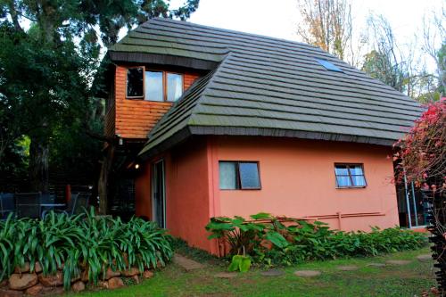 a small red house with a gambrel roof at Treks, Trips and Trails in Champagne Valley