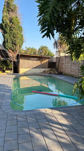 a swimming pool in the middle of a yard at Aneiwa airport lodge in Kempton Park