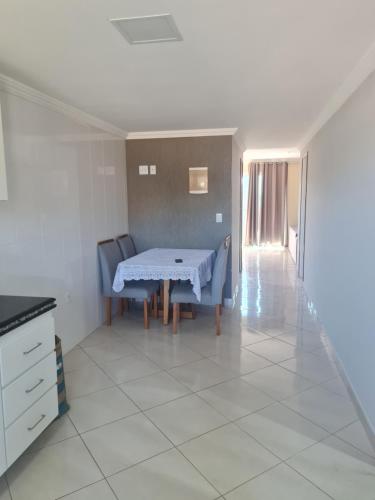 a dining room with a table and two chairs at CasaMelo in São Pedro da Aldeia