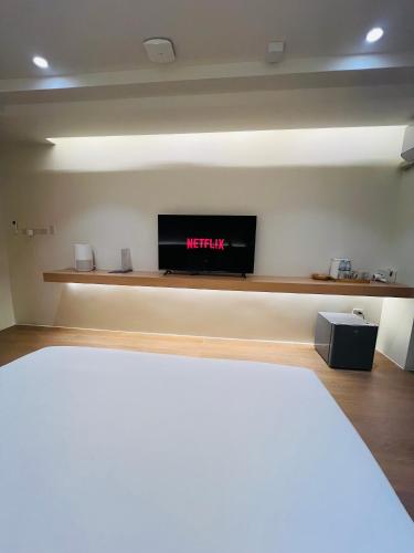 a bedroom with a bed and a tv on a wall at Minitel at Hatyai in Ban Khlong Wa