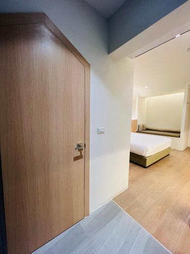 a room with a door and a bed and a bedroom at Minitel at Hatyai in Ban Khlong Wa