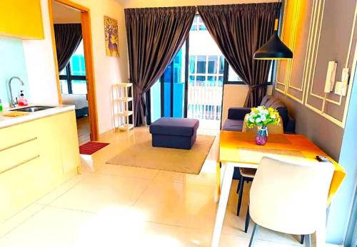 a kitchen and living room with a table and a couch at The Luxe & Colony Infinitum KLCC by CoupleStay in Kuala Lumpur