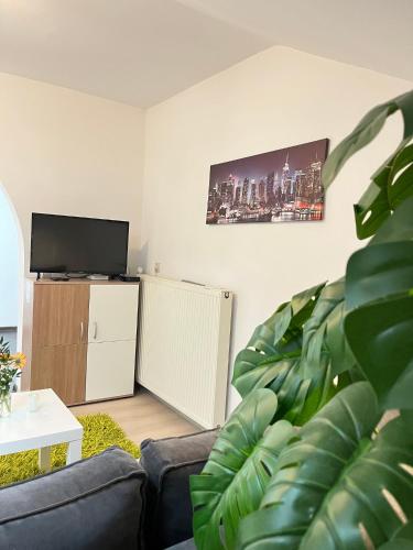 a living room with a couch and a flat screen tv at Apartments Bukor with seasonal pool in Lukovica pri Domžalah