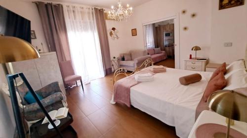 a bedroom with a bed and a living room at La perla di Caserta 2 in Caserta